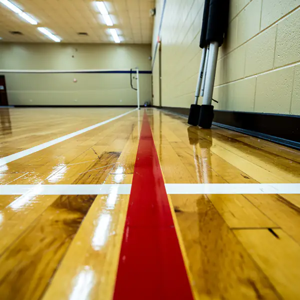 Badminton and volleyball lines on hardwood gym Badminton and volleyball lines on hardwood gym