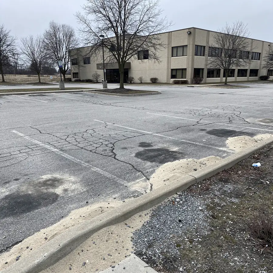 Faded grey parking stall lines early spring